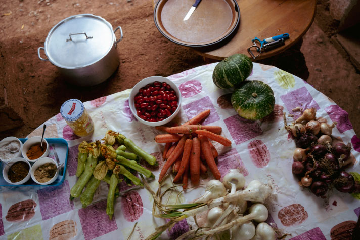 Vegetables and spices on a table with a colourful tablecloth